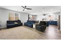Open concept living room with lots of seating, ceiling fan and natural light at 5631 Hill Cliff Ct, North Las Vegas, NV 89031