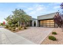 Charming single-story home with a brick driveway, modern design and desert landscaping at 6194 Stone Rise St, Las Vegas, NV 89135