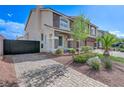 Paver driveway and desert landscaping lead to the home's entrance at 6205 Windy Oaks Ct, Las Vegas, NV 89139