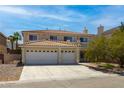 Two-story home featuring a three-car garage, desert landscaping and tile roof at 6251 Tuckaway Cove Ave, Las Vegas, NV 89139