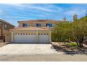 Two-story home featuring a three-car garage, desert landscaping and tile roof at 6251 Tuckaway Cove Ave, Las Vegas, NV 89139