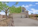 Charming two-story home with a three-car garage and well-maintained desert landscaping at 7211 Heggie Ave, Las Vegas, NV 89131