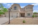Beautiful two-story home with a three-car garage, inviting porch and desert landscaping at 7211 Heggie Ave, Las Vegas, NV 89131