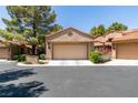 Exterior shot of a garage with a neutral colored door, driveway and desert landscaping at 7217 Mission Hills Dr, Las Vegas, NV 89113