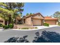 A charming home with a two-car garage, terracotta roof, and desert landscaping at 7217 Mission Hills Dr, Las Vegas, NV 89113