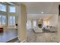 Open concept living room with wood floors, fireplace, and lots of natural light at 7217 Mission Hills Dr, Las Vegas, NV 89113