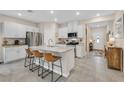 Bright, modern kitchen with a large island, stainless steel appliances, and ample cabinet space at 7910 Pearly Ct, North Las Vegas, NV 89084
