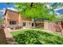 Backyard with a patio, artificial turf, and a well maintained wall at 10220 Adobe Mountain St, Las Vegas, NV 89178