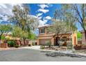 Well-maintained, two-story home with a two car garage and professional landscaping at 10220 Adobe Mountain St, Las Vegas, NV 89178