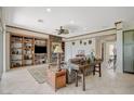 Bright living room with built-in bookshelves, decorative fireplace, and neutral decor at 10562 Cerotto Ln, Las Vegas, NV 89135