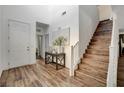 Welcoming foyer with hardwood flooring, a staircase, high ceilings, and an adjacent coat closet at 1114 Junipine Ave, North Las Vegas, NV 89081