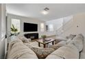 Inviting living room boasts a large sectional sofa and entertainment center with fireplace at 1114 Junipine Ave, North Las Vegas, NV 89081