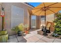 Comfortable patio area with shade umbrella and desert landscaping at 130 Twin Towers Ave, Las Vegas, NV 89123