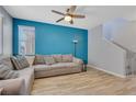 Cozy living room with wood floors, ceiling fan, and staircase access at 1316 Oak Village Ave, Las Vegas, NV 89183