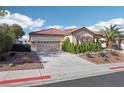 Attractive single-story house with a tile roof, a three-car garage, and desert landscaping in the front yard at 1343 Panini Dr, Henderson, NV 89052