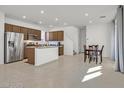 A spacious, well-lit kitchen that flows into the dining area with modern stainless steel appliances at 1388 Graphite Ave, Henderson, NV 89002
