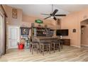 Entertainment area featuring a rustic bar, seating and wood look tile flooring at 1723 Anchor Dr, North Las Vegas, NV 89032