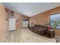 Spacious living room with high ceilings, cozy sofa, and wood-look tile flooring at 1723 Anchor Dr, North Las Vegas, NV 89032