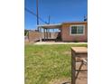 Spacious backyard with a covered patio and mature landscaping for outdoor enjoyment at 1972 H St, Las Vegas, NV 89106