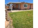 Cozy side yard with green grass, providing an ideal spot for relaxation and recreation at 1972 H St, Las Vegas, NV 89106