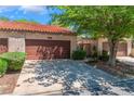 Charming townhome featuring a private garage, quaint landscaping and a terra cotta tiled roof at 2486 Sabado St, Las Vegas, NV 89121