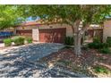 Charming townhome featuring a private garage, quaint landscaping and a terra cotta tiled roof at 2486 Sabado St, Las Vegas, NV 89121