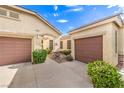 Paired garages give this home plenty of parking, the landscaped entry leads to a cozy desert home at 2561 Pyramid Pines Dr, Henderson, NV 89052