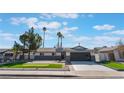 Charming single-story home featuring a putting green and modern garage door at 2909 Gilmary Ave, Las Vegas, NV 89102
