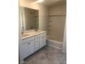 Bathroom features double sinks, white cabinets, and a shower-tub combination at 3270 Trabia Ave, Henderson, NV 89044
