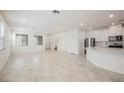 Bright open-concept living room with white walls and modern tile flooring at 3270 Trabia Ave, Henderson, NV 89044