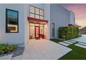Stunning home entrance with a vibrant red door, high ceilings, and modern landscaping at 383 Solitude Peak Ln, Henderson, NV 89012