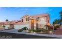 Charming two-story home featuring a well-manicured yard and three-car garage at 3950 Candleglow Ct, Las Vegas, NV 89147