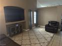Cozy living room featuring a large television and comfortable seating arrangement at 4607 Chestnut Blaze Dr, North Las Vegas, NV 89032
