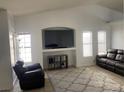Bright living room features tile flooring, neutral paint, and a built-in entertainment center at 4607 Chestnut Blaze Dr, North Las Vegas, NV 89032