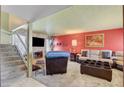 Cozy living room with plush seating, a stone fireplace, and modern decor creating a warm ambiance at 5019 Lancaster Dr, Las Vegas, NV 89120