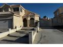 Two-story home showcasing a well-manicured lawn, classic stucco, and a spacious two-car garage at 529 Rancho Del Mar Way, North Las Vegas, NV 89031