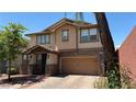 Inviting two-story home with a two-car garage, landscaped yard, and paved driveway at 5627 Spanish Valor Rd, Las Vegas, NV 89135
