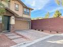 View of a home with a paved driveway and stone accents on the siding at 5627 Spanish Valor Rd, Las Vegas, NV 89135
