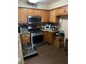 Functional kitchen with stainless steel appliances, ample counter space, and dark backsplash, perfect for cooking enthusiasts at 5710 E Tropicana Ave # 1053, Las Vegas, NV 89122