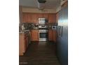 Traditional kitchen featuring stainless steel appliances, wood cabinets, and hardwood flooring at 5710 E Tropicana Ave # 1053, Las Vegas, NV 89122