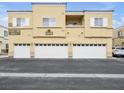 Townhouse exterior featuring multi-car garages and clean lines at 6324 Desert Leaf St # 3, North Las Vegas, NV 89081