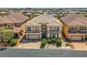 Expansive view of the neighborhood showcasing a two-story home with a well-manicured front yard and solar panels at 6750 Quapaw St, Las Vegas, NV 89149