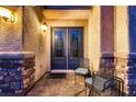 Inviting front porch with double doors and chairs, perfect for relaxing outdoors at 6750 Quapaw St, Las Vegas, NV 89149