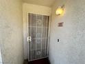 Inviting front door with a security screen and a well-lit entrance at 698 S Racetrack Rd # 322, Henderson, NV 89015