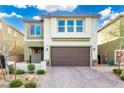 Charming two-story home featuring a brick-paved driveway and a well-maintained, drought-resistant landscaped yard at 7733 Rosebark Cliffs St, North Las Vegas, NV 89084