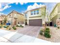Charming two-story home featuring a brick-paved driveway and a well-maintained, drought-resistant landscaped yard at 7733 Rosebark Cliffs St, North Las Vegas, NV 89084