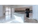 Functional kitchen featuring a center island, granite countertops, and stainless steel appliances at 787 Craigmark Ct, Henderson, NV 89002