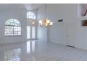 Bright, open living room with tile floors, soaring ceilings, and large windows at 787 Craigmark Ct, Henderson, NV 89002