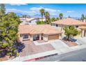 Beautiful aerial view of a single-story home with a tile roof and desert landscaping at 8504 W Gilmore Ave, Las Vegas, NV 89129
