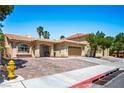 Inviting single-story home with a brick driveway and attached two-car garage at 8504 W Gilmore Ave, Las Vegas, NV 89129